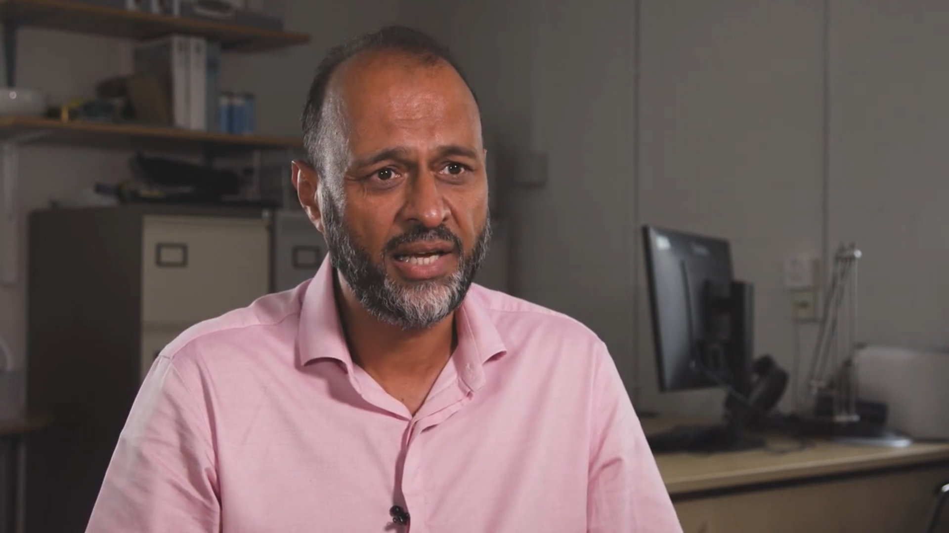 Javed Khan sits in front of the camera, shoulders up visible